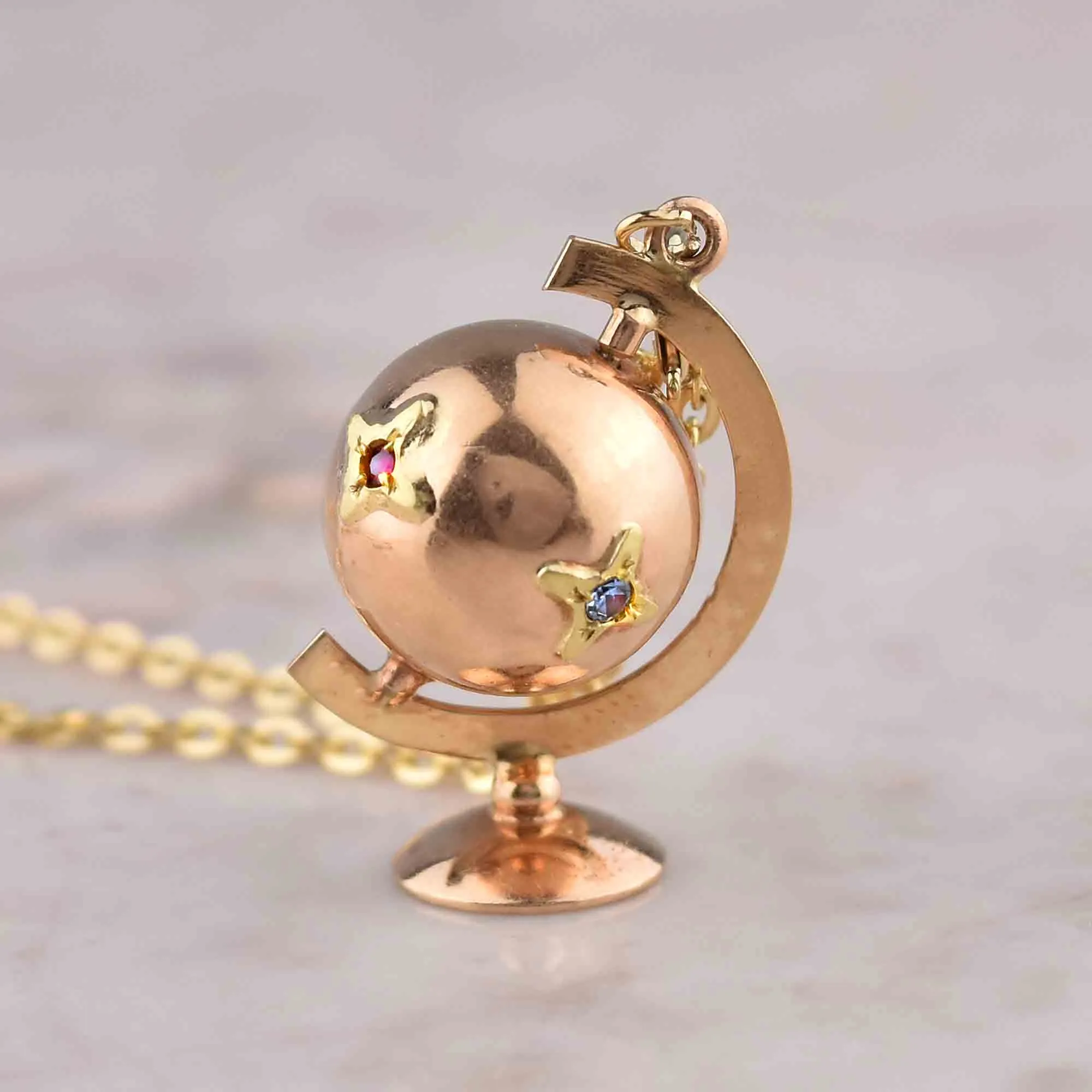 Charming 18K Gold Spinning Globe Topaz Ruby Star Pendant