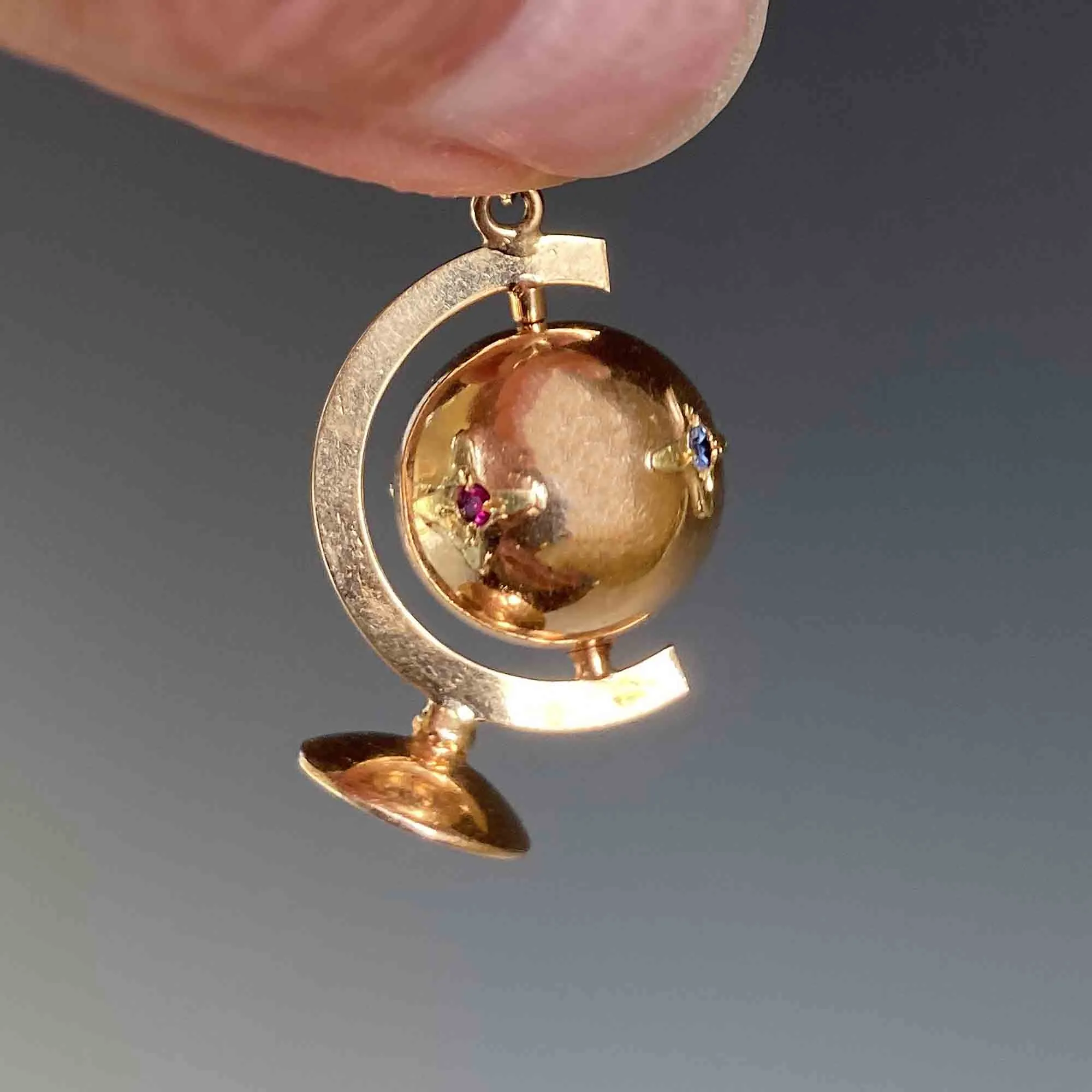 Charming 18K Gold Spinning Globe Topaz Ruby Star Pendant