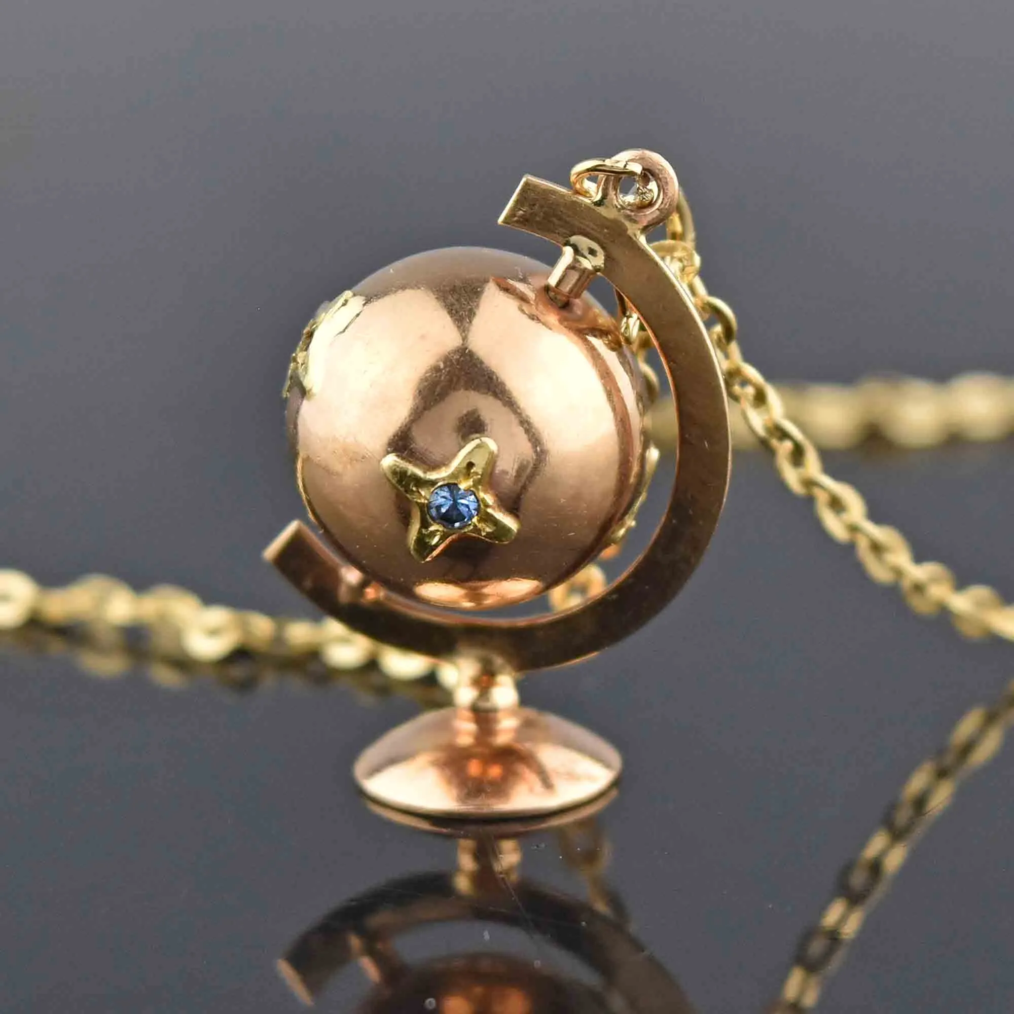 Charming 18K Gold Spinning Globe Topaz Ruby Star Pendant