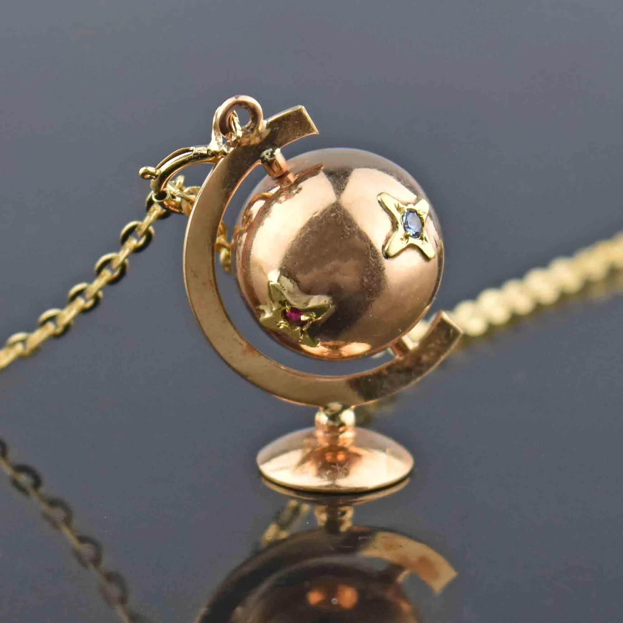 Charming 18K Gold Spinning Globe Topaz Ruby Star Pendant